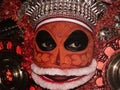 a closeup headshot portrait of a theyyam artist