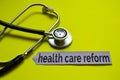 Closeup health care reform with stethoscope concept inspiration on yellow background