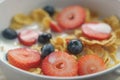 Closeup of healthy breakfast with corn flakes and berries in white bowl Royalty Free Stock Photo