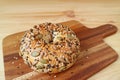 Closeup a healthy pumpkin seed and sunflower seed with sesame bagel on wooden breadboard Royalty Free Stock Photo