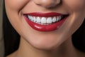closeup of a wide healthy smile with perfect white teeth of a young woman with red lips