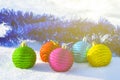 Closeup heap of christmas toys lie on snow in sunlight