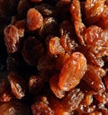 Closeup of a heap of dry sultana grapes with light falling on them