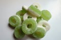 Closeup of heap of green and white sugar coated jelly ring candies