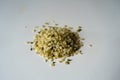 Closeup of heap of greenish yellow shelled hemp seeds Royalty Free Stock Photo