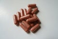 Closeup of heap of pink capsules of PQQ dietary supplement