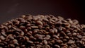 Closeup heap roasted coffee grains on dark backdrop. Coffee beans background. Royalty Free Stock Photo