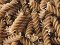Closeup of a heap of uncooked twisted pasta