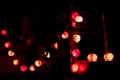 Closeup heart shape of led lights line hanging on the wooden chairs decorated in the darkroom