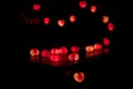 Closeup heart shape of led lights line puts on the wooden table decorated in the darkroom