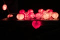 Closeup heart shape of led lights line puts on the wooden table decorated in the darkroom