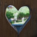 Closeup of a heart shaped hole on a wooden door Royalty Free Stock Photo