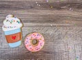 Closeup of latte and donut sugar cookies on a wooden background