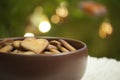 Closeup with hearts of gingerbread cookies on background of Christmas tree lights Royalty Free Stock Photo