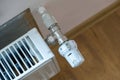 Closeup of heating radiator valve for comfortable temperature regulation on metal radiator on inrerior wall