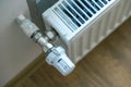 Closeup of heating radiator valve for comfortable temperature regulation on metal radiator on inrerior wall