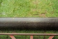 Closeup heavy steel drum for pressing the lawn field during growing the grass with blurred green landscape in background