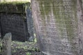 Closeup of Hebrew engravings on old stones in a graveyard under the sunlight