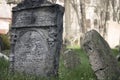 Closeup of Hebrew engravings on old stones in a graveyard under the sunlight