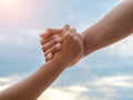 Closeup helping hands on the sky background. Rescue & Help Cencept Royalty Free Stock Photo