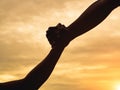 Closeup helping hands on the sunset sky background. Rescue & Help Cencept Royalty Free Stock Photo