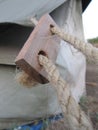 Closeup of a hemp rope tightening the side of a ridge tent and flysheet during camping