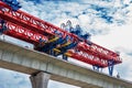 Closeup of high-elevation railway construction crane by modern technology with cloud sky background Royalty Free Stock Photo