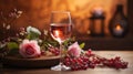 Closeup on a high glass of rosÃ© wine on a wooden table with few pink Roses and some red grappes Royalty Free Stock Photo