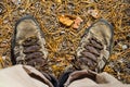 Closeup hiker feet stay on the ground with dry leaves