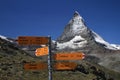 Closeup of a hiking trail sign post with the alpine Matterhorn on the background Royalty Free Stock Photo
