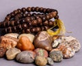 Closeup of holistic stones and bracelet isolated in gray background Royalty Free Stock Photo