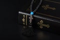 Closeup of Holy Bible and rosary beads with cross on black background. Religion concept and faith Royalty Free Stock Photo