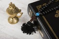 Closeup of Holy Bible, rosary beads with cross and incense burner on white wooden background. Religion concept and faith Royalty Free Stock Photo