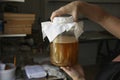 Closeup of homemade fermented Kombucha tea in a person`s hands