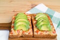 Homemade grilled cheese toast with tomato and sliced fresh avocado on top Royalty Free Stock Photo