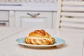 Closeup homemade sweet bun on plate on table in Royalty Free Stock Photo