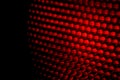 Closeup honeycomb grid texture with red light. Red and dark metal hexagon shaped pattern abstract background. Light modifier