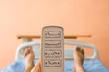 Closeup of a hospital bed remote control in hand of a patient lying in the hospital ward Royalty Free Stock Photo