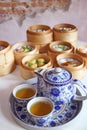 Hot Chinese Oolong Tea Set with Blurry Assorted Dim Sum Dishes
