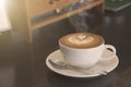 Closeup hot coffee latte art cup with smoke Royalty Free Stock Photo