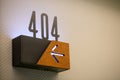 Closeup of 404 hotel room number with an arrow sign showing the direction Royalty Free Stock Photo