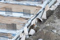 Closeup of house foundation made from concrete shuttering blocks filled with mortar and reinforcement bars