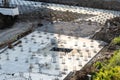 Closeup of house foundation made from concrete shuttering blocks filled with mortar and reinforcement bars