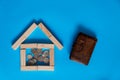 Closeup of house wooden model and keys with calculator on blue background. Mortgage property insurance buy dream home Royalty Free Stock Photo