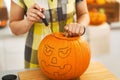 Closeup on housewife carving a big orange pumpkin Jack-O-Lantern Royalty Free Stock Photo