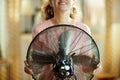 Closeup on housewife cooling down in the front of working fan Royalty Free Stock Photo