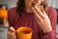 Closeup on housewife drinking tea with bread Royalty Free Stock Photo