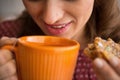 Closeup on housewife drinking tea with bread Royalty Free Stock Photo