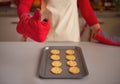 Closeup on housewife in kitchen gloves showing christmas cookies Royalty Free Stock Photo