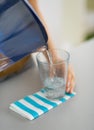 Closeup on housewife pouring water into glass Royalty Free Stock Photo